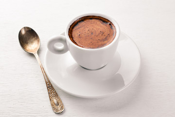 Espresso coffee cup on a white wooden background. Top view. Free space for text.