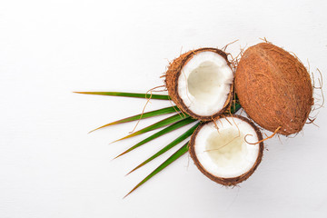 Coconut on a wooden background. Tropical fruits and nuts. Top view. Free space for text.
