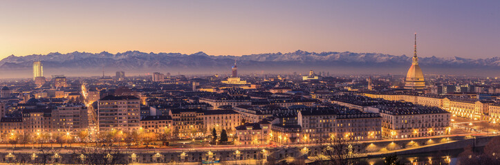 Fototapeta na wymiar Turin, Italy: cityscape at sunrise with details of the Mole Antonelliana of Torino