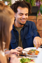 happy couple eating at restaurant