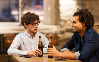 happy male friends drinking beer at bar or pub
