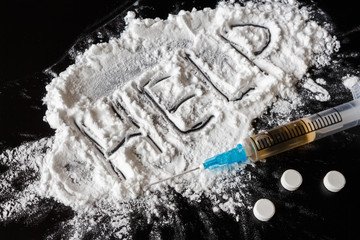 Drug heroin, syringes, money on a dark background with the inscription help and copy space, the...