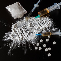 Drug heroin, syringes, money on a dark background with the inscription help and copy space, the...
