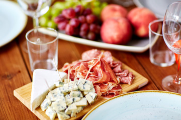 blue cheese and jamon ham on wooden table