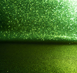 Naklejka premium green glitter lights background. defocused
