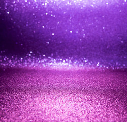 Purple glitter lights christmas bokeh background. defocused