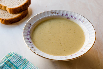 Broccoli Soup with Bread on Ceramic Surface.