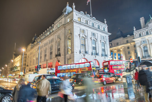 LONDON - OCTOBER 2013: Tourists walk in Piccadilly Circus, long exposure view. London attracts 30 million visitors annually