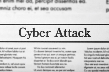 Headline "Cyber attack" in newspaper, closeup