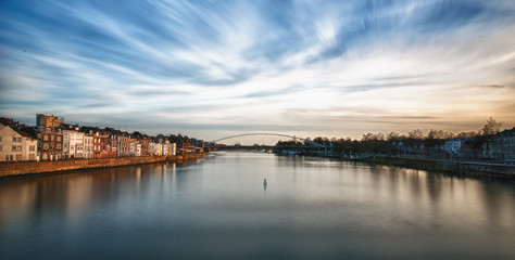 The River Mass floats by .