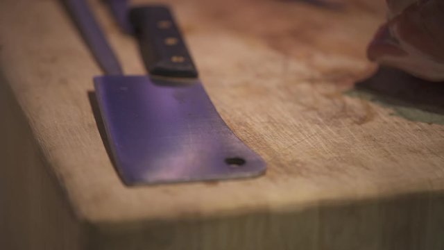 Sharp big butcher's knife on a wooden cutting board