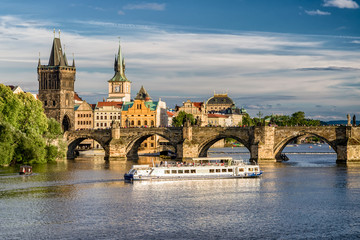 Charles bridge and cruiseship on river Vltava, Prague - Czech republic