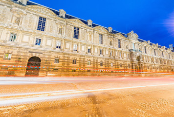 Obraz premium Ancient Paris building with car light trails, France