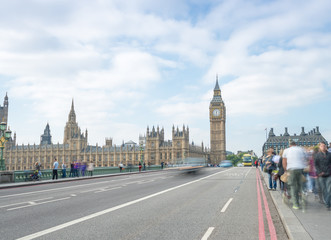 Fototapeta na wymiar LONDON - SEPTEMBER 29, 2013: Tourists walk along Westminster Bridge, long exposure view. London attracts 30 million visitors every year