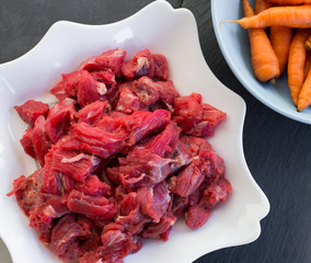 Raw beef meat on a white plate