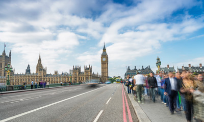 Tourists walking along Westminster Bridge in London. Long exposure shot