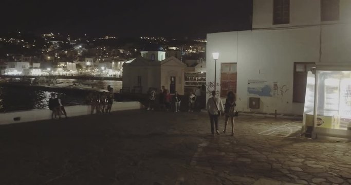 SANTORINI, GREECE – AUGUST 2016 : Video shot on promenade at night with people and cityscape in view