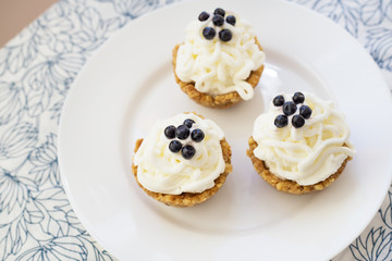 Homemade cupcake with blueberries, cream and fresh berries.