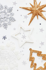 Christmas and New Year background with sparkling fir tree, snowflakes and star confetti. Holiday symbols on white background with place for text.