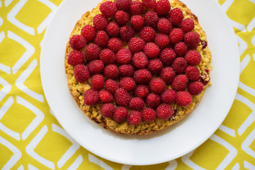 bright crimson-sand cake on yellow napkin, top view.
