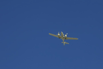 a small white plane flying in the sky