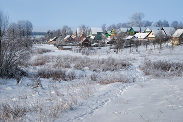 Village in a winter day and snow. Russia