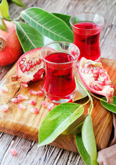 Fresh pomegranates and juice, selective focus