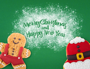 Christmas cookies of different shapes and sizes with a festive decor on a green background. Holiday Poster concept.  Empty place for a postural inscription