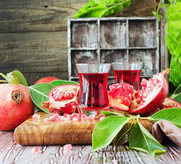 Fresh pomegranates and juice, selective focus