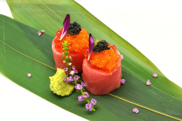 Otoro roll special (caviar roe, salmon roe, maguro, otoro) in white plate on white background © Rattana