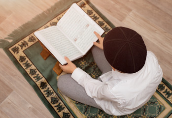little boy read the Quran