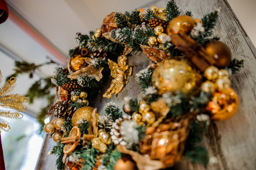 Beautiful Christmas wreath made of fir tree and toys