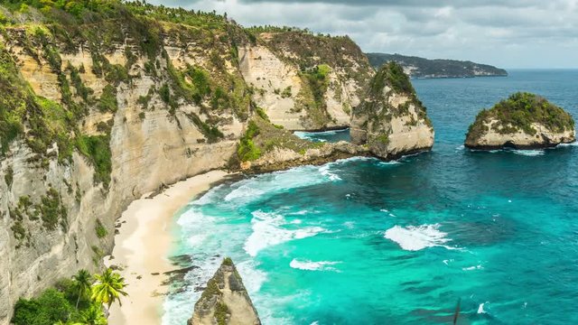 Timelapse Rocky coast in the ocean with big waves at Atuh beach on Nusa Penida island, Indonesia