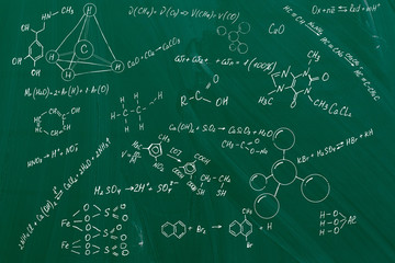 Chemical formulas written on chalkboard background