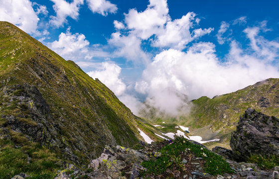 clouds rising above the mountain ridge. lovely summer scenery in Fagaras mountains, Romania