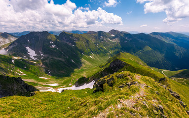 path along the mountain ridge with snow on hills. Gorgeous summer scenery in Fagaras mountains of Romania