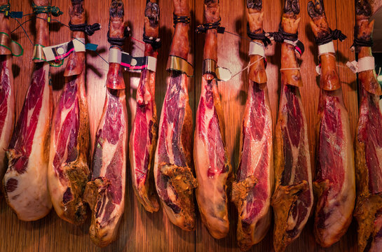 Spanish cured ham hanging in Boqueria Market, Barcelona, Catalonia, Spain, Europe