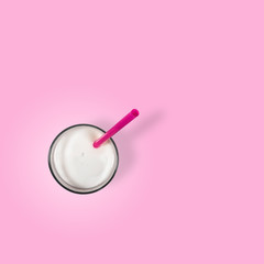 a glass of milkshake with a straw