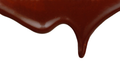 Close up of chocolate syrup leaking on white background