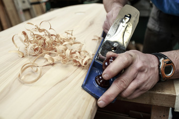 Carpenter planing surfboard