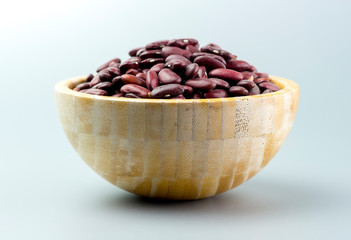 Side view of wooden bowl full of kidney beans