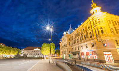Fototapeta na wymiar KLAGENFURT, AUSTRIA - AUGUST 21, 2013: Main square at night. Klagenfurt is a major destination in Austria