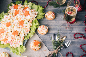 Crab salad tarts on wooden background. Christmas holiday buffet table served by snacks.  Line of canape