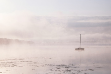 Morning mist over lake with sailboat - 4