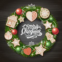 Top view of Merry Christmas concept design. Christmas wreath with cookies on wooden background. Christmas food