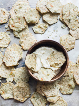 Multi-grain crackers with hummus dip, close-up