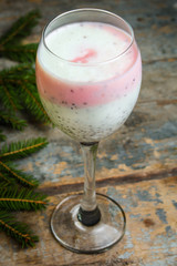 cocktail in a high-necked glass with berries, chia seeds, etc.