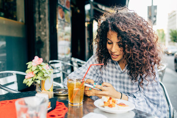 Woman at pavement cafe, Milan, Italy