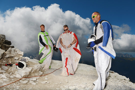 Base jumpers on dolomite mountains wearing wingsuits, Canazei, Trentino Alto Adige, Italy, Europe