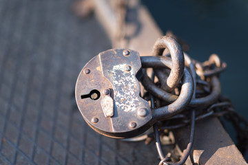 old key lock locked with a chain